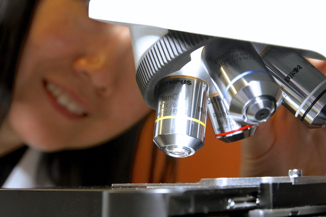 Student looking through a microscope