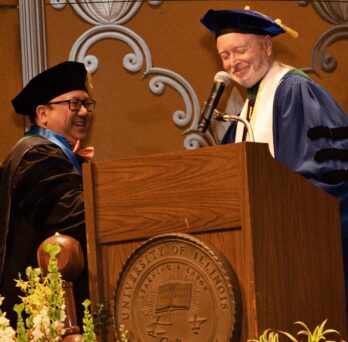 Raymond Garcia, MD, accepts the Distinguished Service Award from Dean Stagnaro-Green during the Convocation Ceremony. 