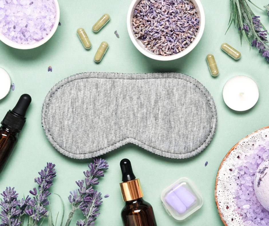 gray eye mask with  dried lavender on green background