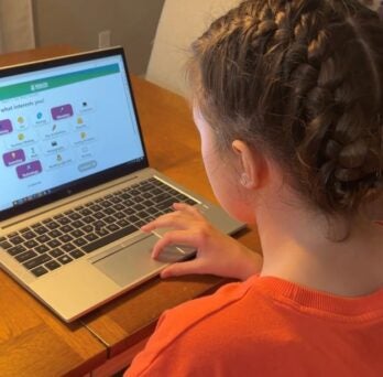A girl uses the Health Careers Guide on her laptop
                  