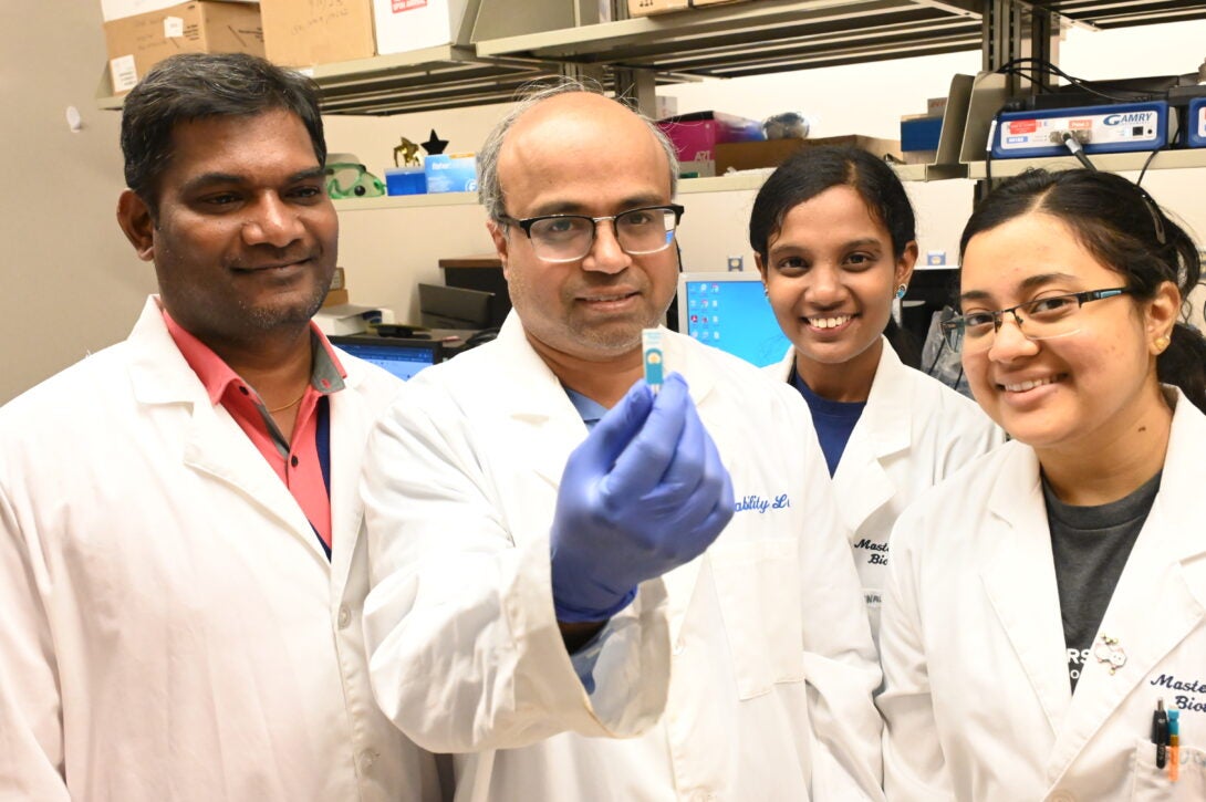 Mathew Mathew Thoppil, PhD, (second from left) surrounded my his students.