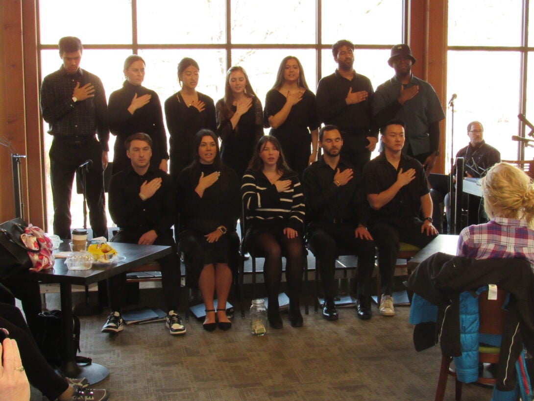 Students singing in black outfits.