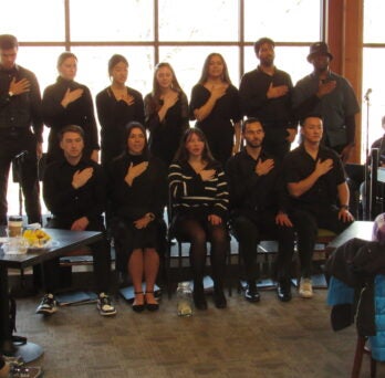 Students singing in black outfits. 