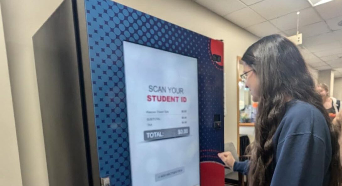 A student uses the health vending machine in Student Health and Wellness