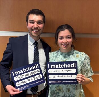 Medical students holding their match signs 