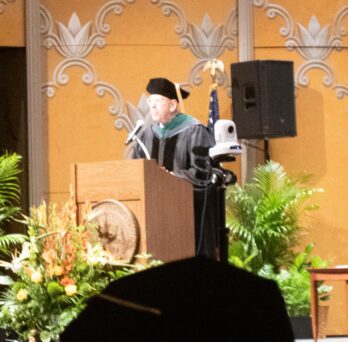 James Girardy, MD, a clinical professor in the UICOMR Department of Surgery and Surgical Specialties, addresses the crowd during UICOMR's Convocation Ceremony. 